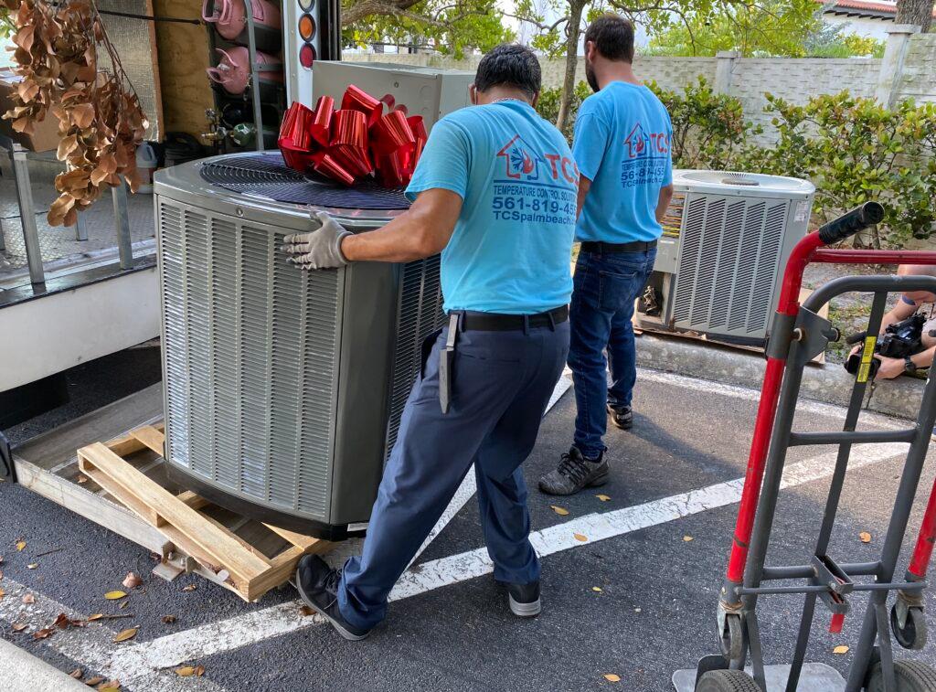 Temperature Control Solutions employees install Trane HVAC units.