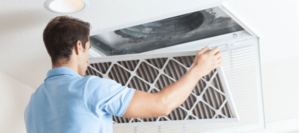 A man changes an indoor air filter