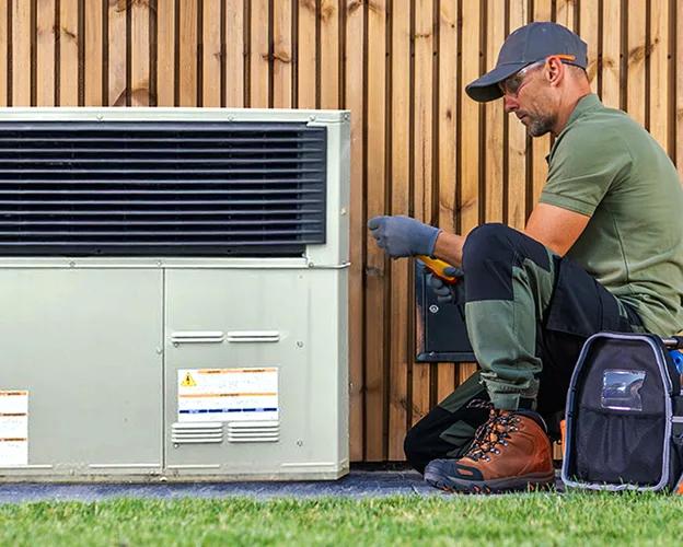 Trane technician servicing an outdoor HVAC unit