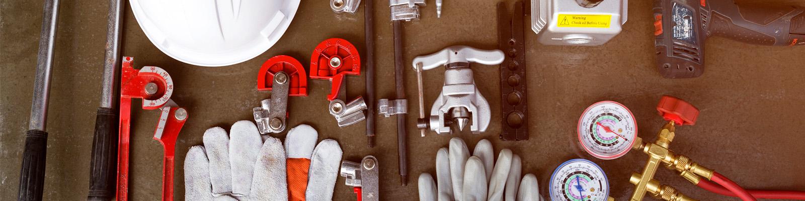 There is a selection of HVAC tech tools laid out on a table.