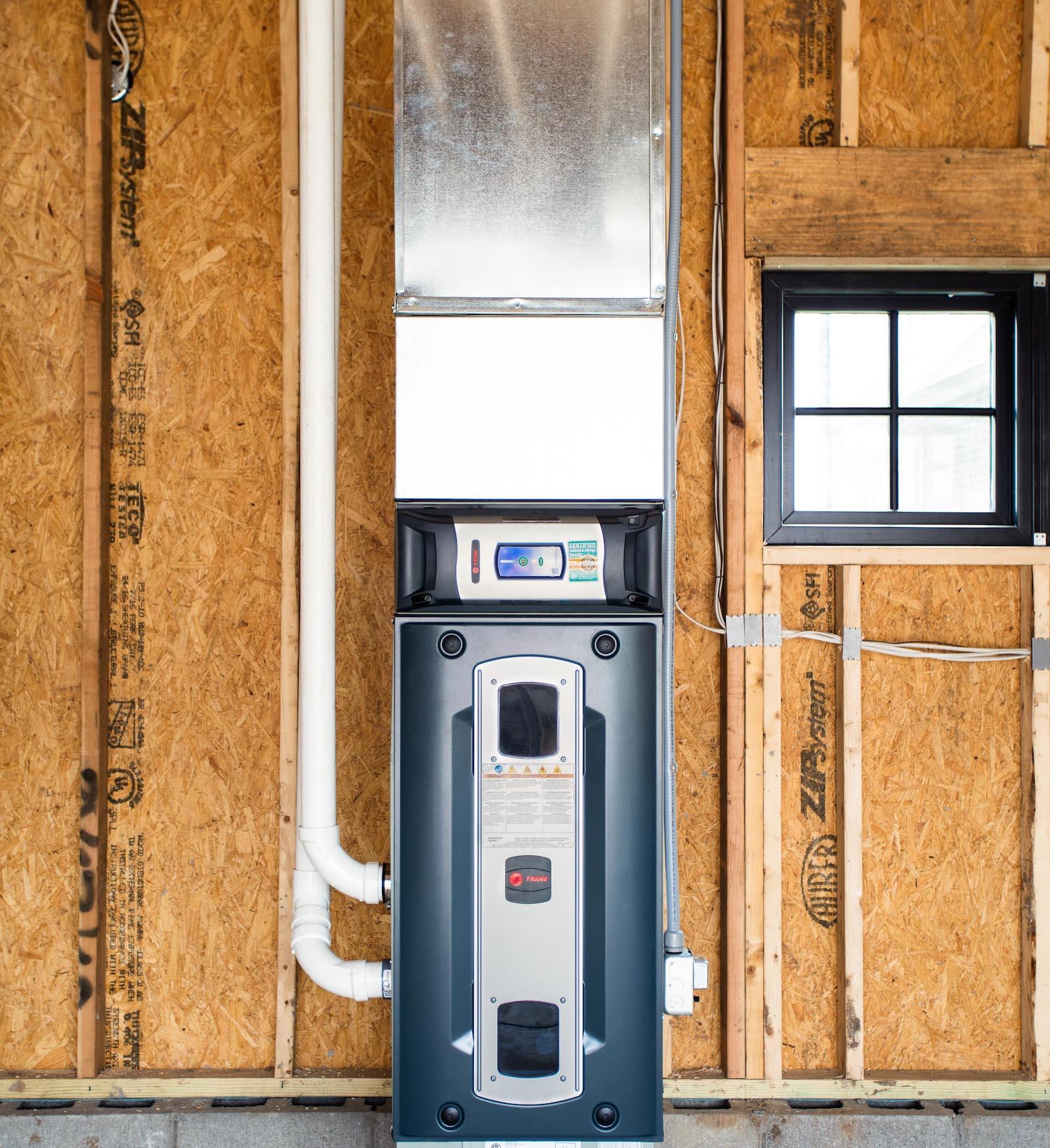 An air purification system and HVAC system are installed in an unfinished room.