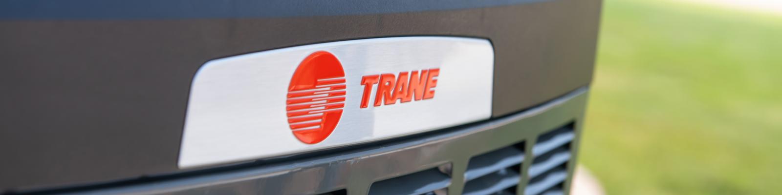 Close up shot of the Trane logo on an outdoor HVAC unit.