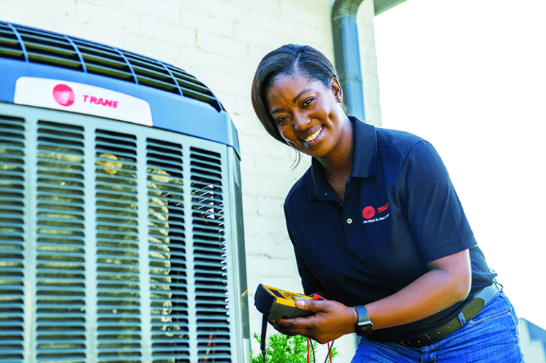 A Trane technician with a Trane air conditioning unit.