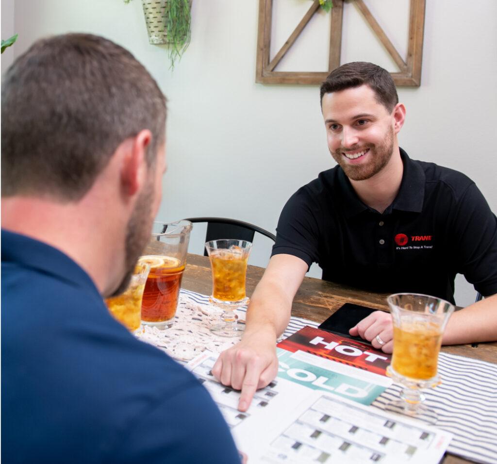 An HVAC dealer talks with a customer.