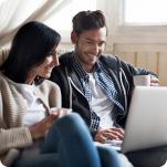 A couple researching savings in their home.