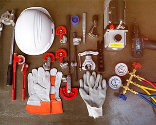 There is a selection of HVAC tech tools laid out on a table.