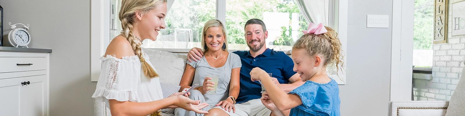 Family in the Summer Inside Home with Girls Playing Cards