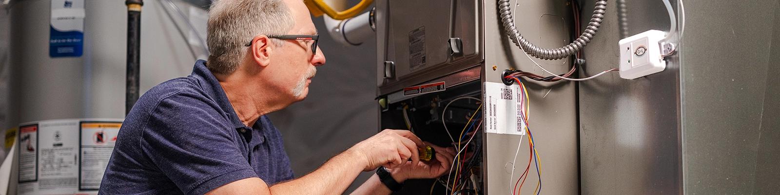 HVAC Technician Installing the HVAC Performance Monitoring Kit