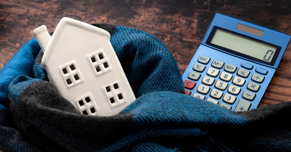 There is a white plastic home replica and a blue calculator.