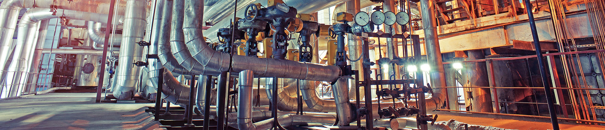 Equipment, cables and piping as found inside of a modern industrial power plant