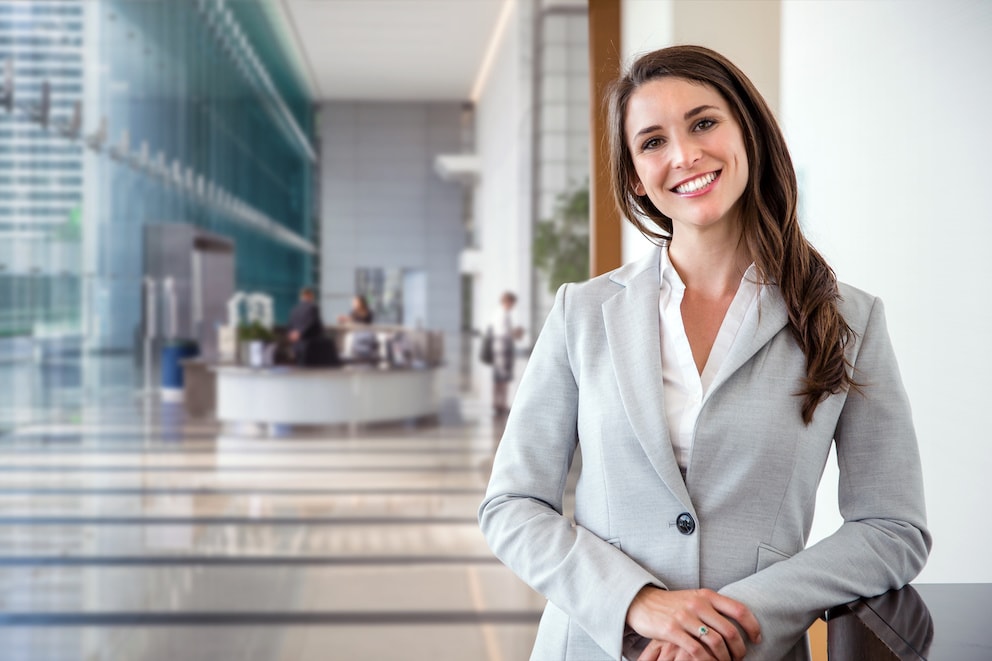 Smiling likable sincere and charming business woman financial executive type portrait inside commercial building