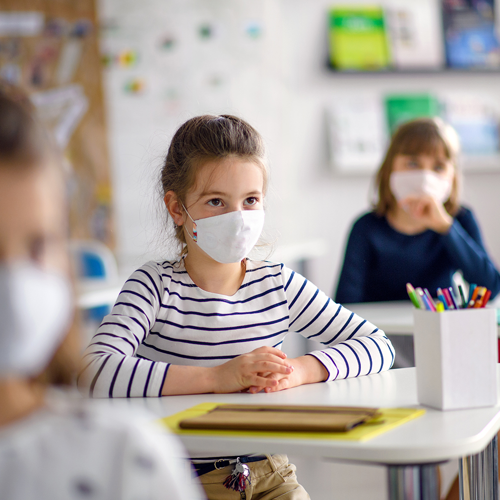 Children with face mask back at school after covid-19 quarantine and lockdown.