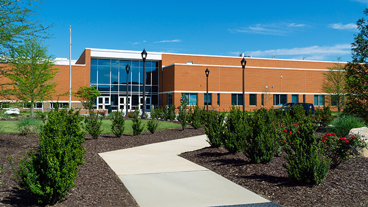 Exterior view of a modern school building entrance with landscaping