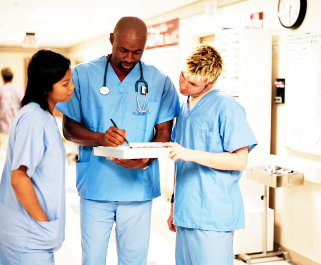 Hospital workers meeting in hallway