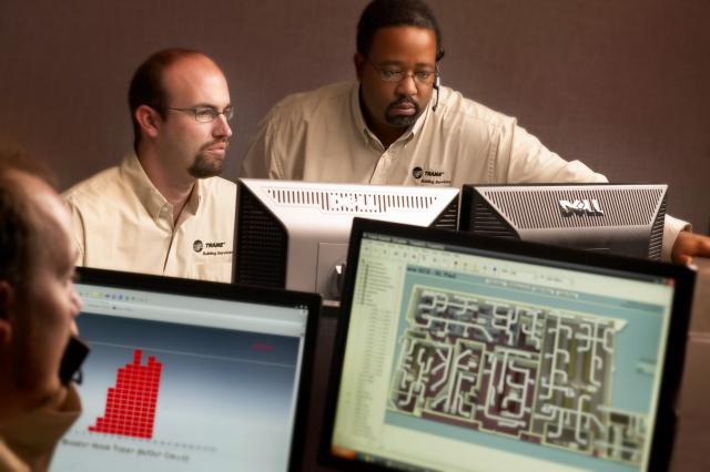 Trane workers checking systems on computers