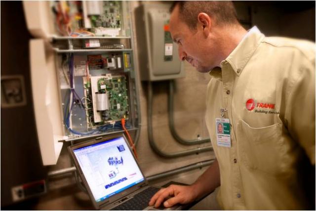 Trane worker checking on system