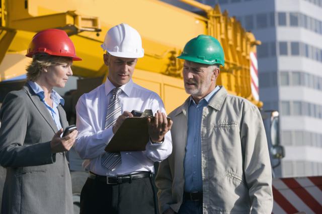 Engineers discussing what is on a clipboard