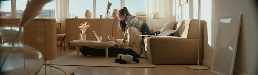 Mother working from home, her daughter distracts her and drawing attention