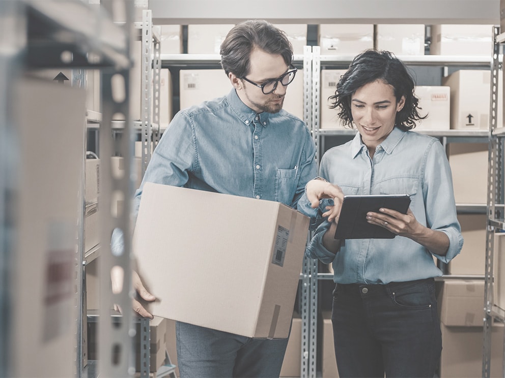 Female manager showing tablet to male employee