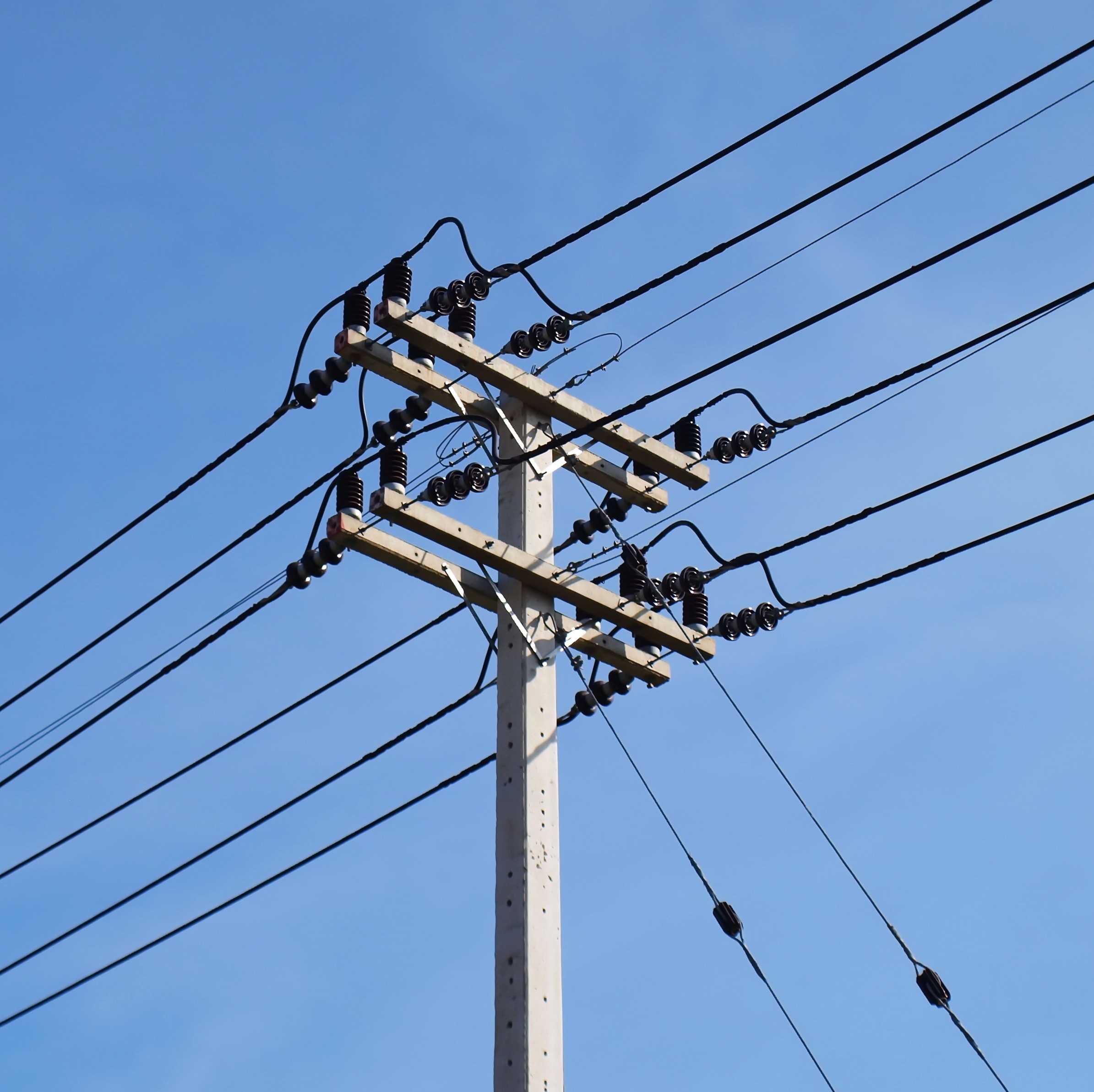 High voltage cable on the pole On the blue sky background With copy space