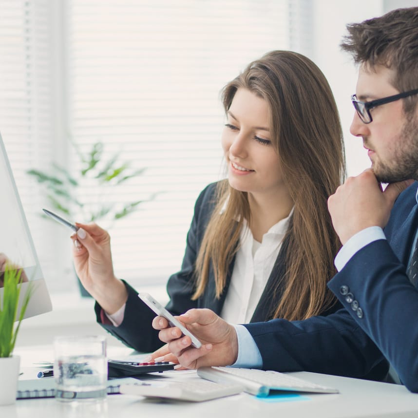 Young businessman discussing something with his colleague, and using a digital tablet together